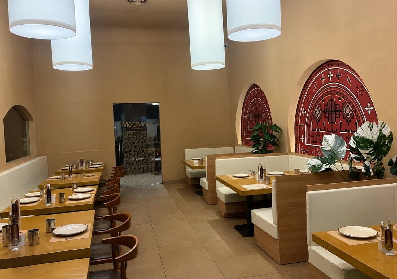 Booth seating and geometric wall art at QumQum